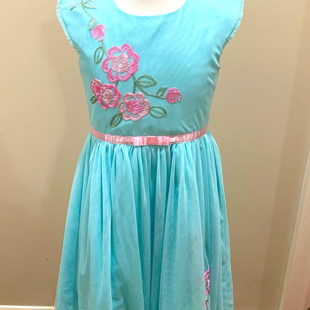 A teal flowery dress, with button back and bow tie, great condition.